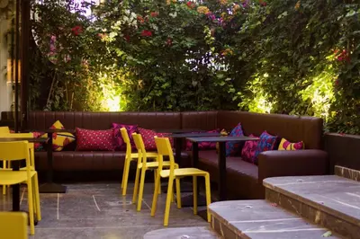 a couch with yellow chairs and a table and chairs at Boutique Hotel Gauthier Restaurant Terrasse in Casablanca