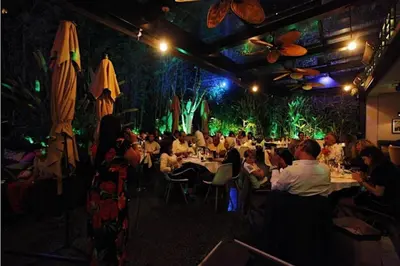 a group of people sitting at tables in a restaurant at Boutique Hotel Gauthier Restaurant Terrasse in Casablanca