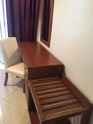 a wooden desk with a chair in a room at Hotel Boustane in Casablanca