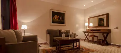 a living room with a couch and a table at Soundouss Hotel in Rabat