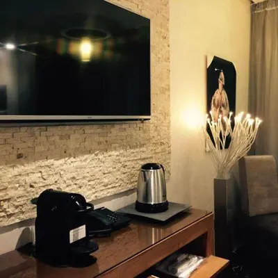 a living room with a television on a wall at The Seven Hotel in Casablanca