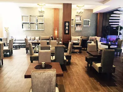 a restaurant with tables and chairs in a room at The Seven Hotel in Casablanca