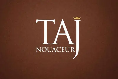 a white logo with a crown on a brown background at Short Stay Apartment aéroport casablanca in Nouaseur