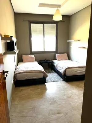 a room with two beds and a window at Short Stay Apartment aéroport casablanca in Nouaseur