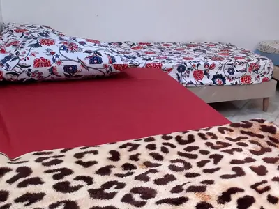 a room with two beds with a leopard print blanket at Zitouna Rooms in Casablanca