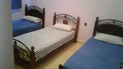a bedroom with two beds with blue sheets at Zitouna Rooms in Casablanca