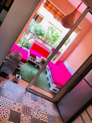 an aerial view of a patio with pink furniture at Un Havre de paix a Ricoflores in Mohammedia