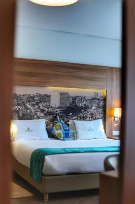 a bedroom with a large bed with a wall at Melliber Appart Hotel in Casablanca