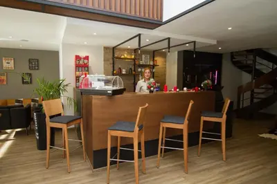 a woman standing behind a bar in a restaurant at Melliber Appart Hotel in Casablanca