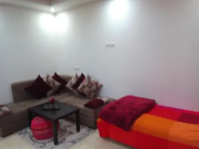 a living room with a couch and a table at Studios Taha in Rabat