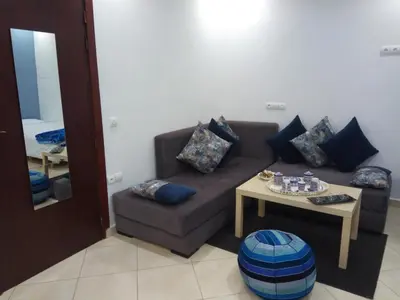 a living room with a couch and a table at Studios Taha in Rabat