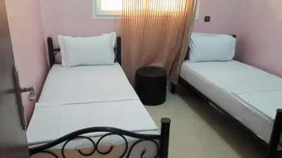 a pair of beds in a small room at Reem in Temara