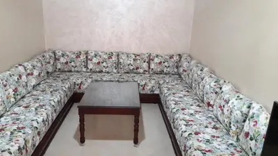 a couch with a coffee table in a room at Reem in Temara