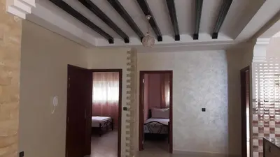 a hallway with two doors and a bed in a room at Reem in Temara