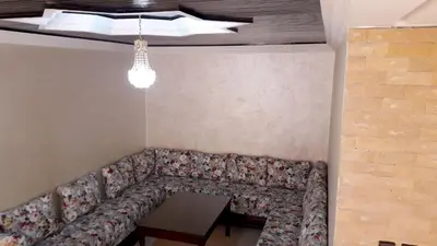 a couch in the corner of a room with a table at Reem in Temara