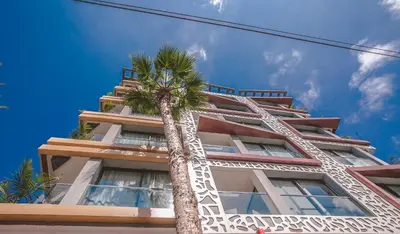 a palm tree in front of a building at DownTown Hotel Maârif Casablanca By TSA in Casablanca