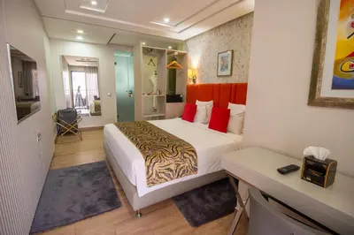 a hotel room with a bed and a desk at DownTown Hotel Maârif Casablanca By TSA in Casablanca