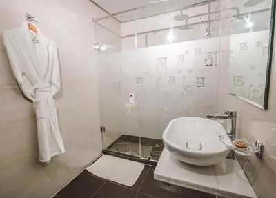 a bathroom with a toilet and a glass shower at DownTown Hotel Maârif Casablanca By TSA in Casablanca