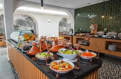 a buffet line with bowls of food on a table at DownTown Hotel Maârif Casablanca By TSA in Casablanca