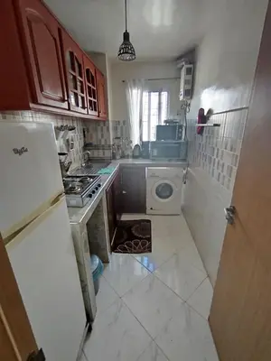 a kitchen with a refrigerator and a washing machine at appartement plage Bouznika in Bouznika