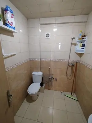a small bathroom with a toilet and a shower at appartement plage Bouznika in Bouznika