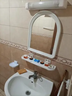 a bathroom with a sink and a mirror at appartement plage Bouznika in Bouznika