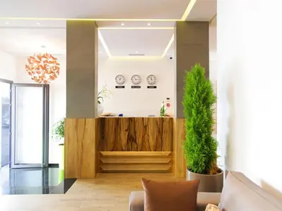 a living room with a wooden counter and plants at Smarts Hotel Agdal Rabat in Rabat