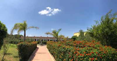 a cloud in the sky above a garden with flowers at Riad Hamdani in Casablanca