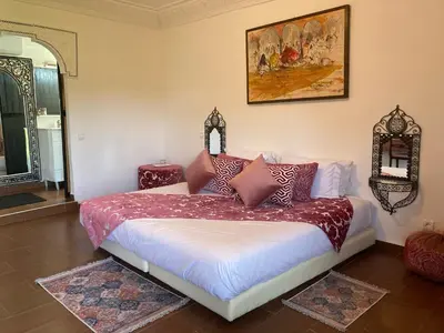 a bedroom with a bed with pillows on it at Riad Hamdani in Casablanca