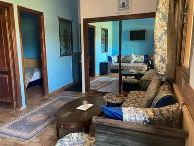 a living room with a couch and a table at Riad Hamdani in Casablanca