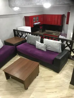 a living room with a couch and a kitchen at Casablanca centre ville in Casablanca