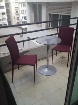 a table and two chairs sitting on a balcony at Casablanca centre ville in Casablanca