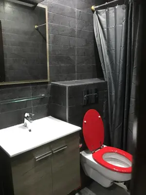 a bathroom with a red toilet and a sink at Casablanca centre ville in Casablanca