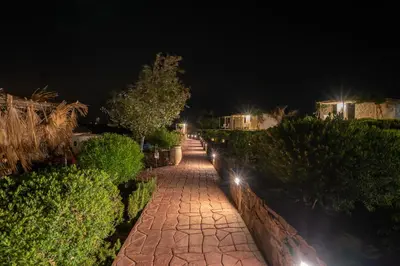 a brick pathway at night with lights on it at Safa Boulaouane in Douar Annbirat