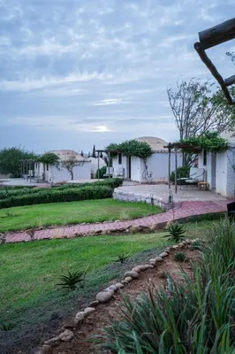 a view of a yard with a lake and buildings at Safa Boulaouane in Douar Annbirat