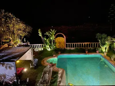 a swimming pool in a yard at night at Aux Moules de Harhoura Rabat in El Harhoura