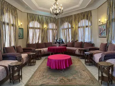 a living room with couches and a table in a room at Aux Moules de Harhoura Rabat in El Harhoura