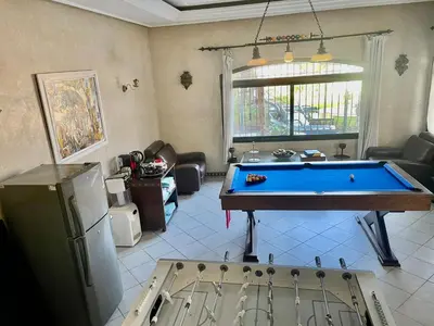 a living room with a pool table in it at Aux Moules de Harhoura Rabat in El Harhoura