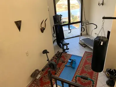 a room with a gym with a treadmill and a tread machine at Aux Moules de Harhoura Rabat in El Harhoura