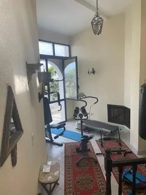 a room with a gym with exercise equipment in it at Aux Moules de Harhoura Rabat in El Harhoura
