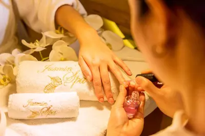 a woman getting her nails done in front of a cake at Le Casablanca Hotel in Casablanca