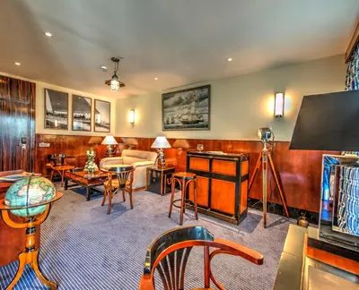 a living room with a couch and a table and chairs at Le Casablanca Hotel in Casablanca