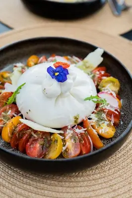 a bowl of food with a flower on top of it at Le Casablanca Hotel in Casablanca