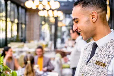 a man wearing a vest and a tie at Le Casablanca Hotel in Casablanca