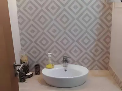 a white sink in a bathroom with a wall at Appartement ,Tram Parking and wifi gratui in Casablanca