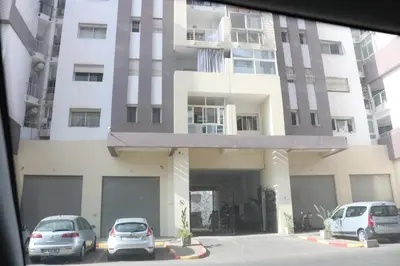 two cars parked in front of a building at Appartement ,Tram Parking and wifi gratui in Casablanca