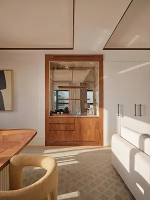 a living room with a table and a wooden door at The View Rabat in Rabat