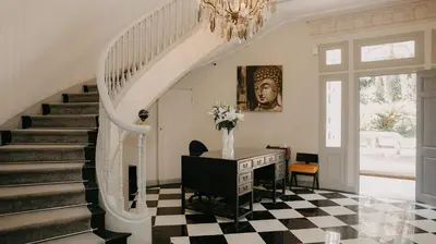 a staircase in a home with a vase of flowers at Villa Soraya Lodge & Spa in Rabat