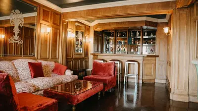 a living room with red furniture and a fireplace at Villa Soraya Lodge & Spa in Rabat