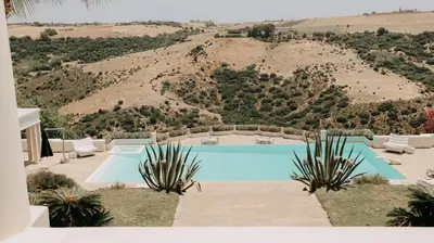 a swimming pool with a mountain in the background at Villa Soraya Lodge & Spa in Rabat